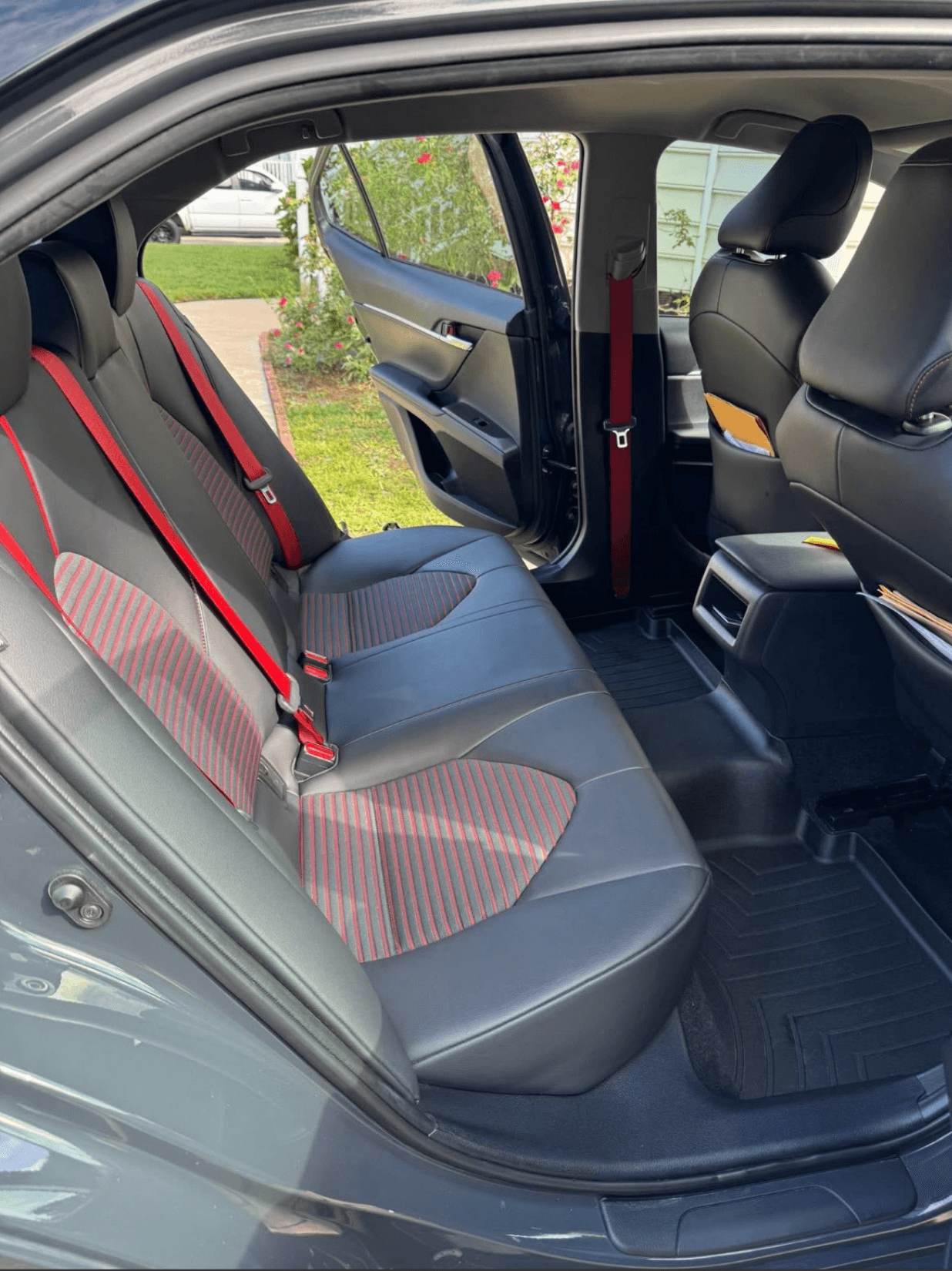 Rear seats of a Toyota Camry TRD with red-stitched bolsters after a full interior clean